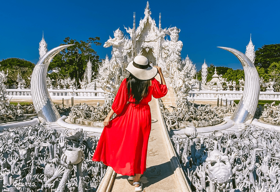Lady in red dress standing in front of the White Temple during the Chiang Rai tour.