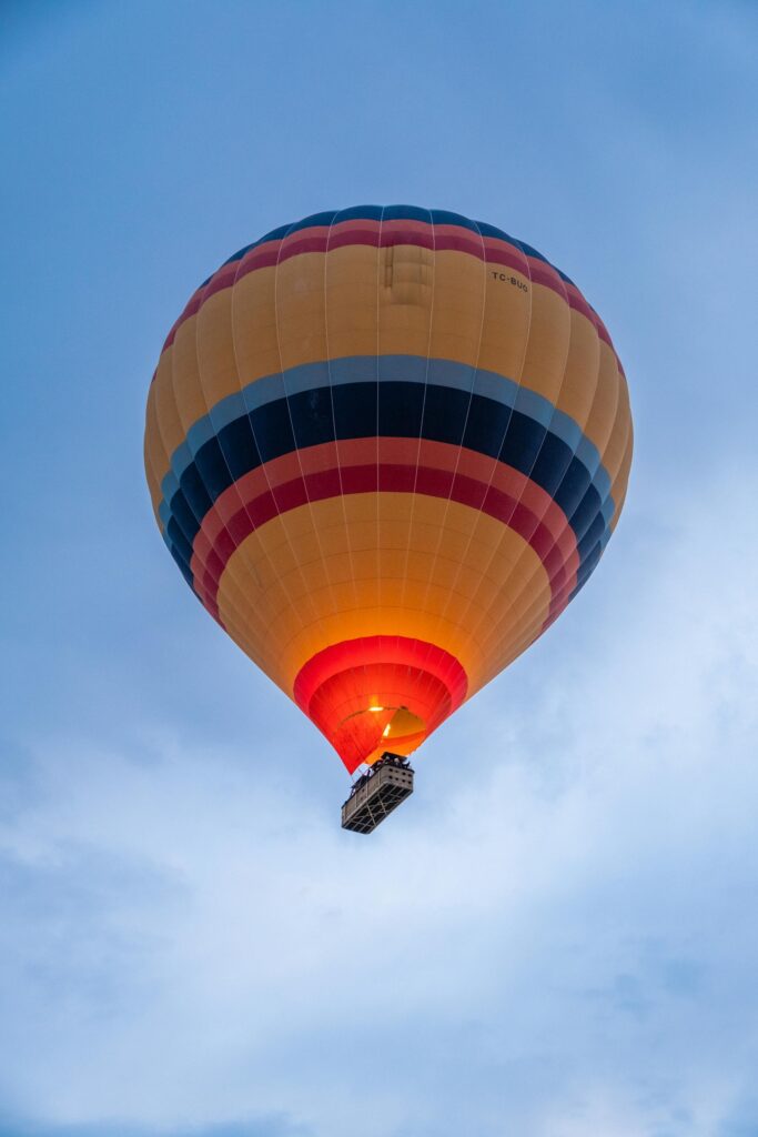 a colorful hot air balloon floating in the blue sky