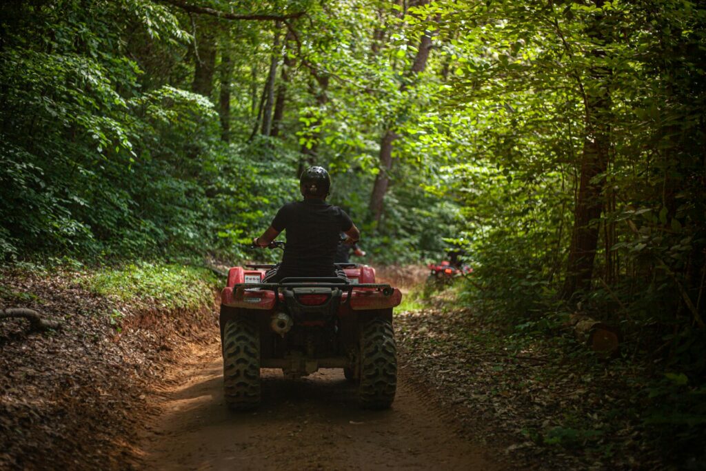 a man driving an ATV along the atv trail in the mountain in chiang mai